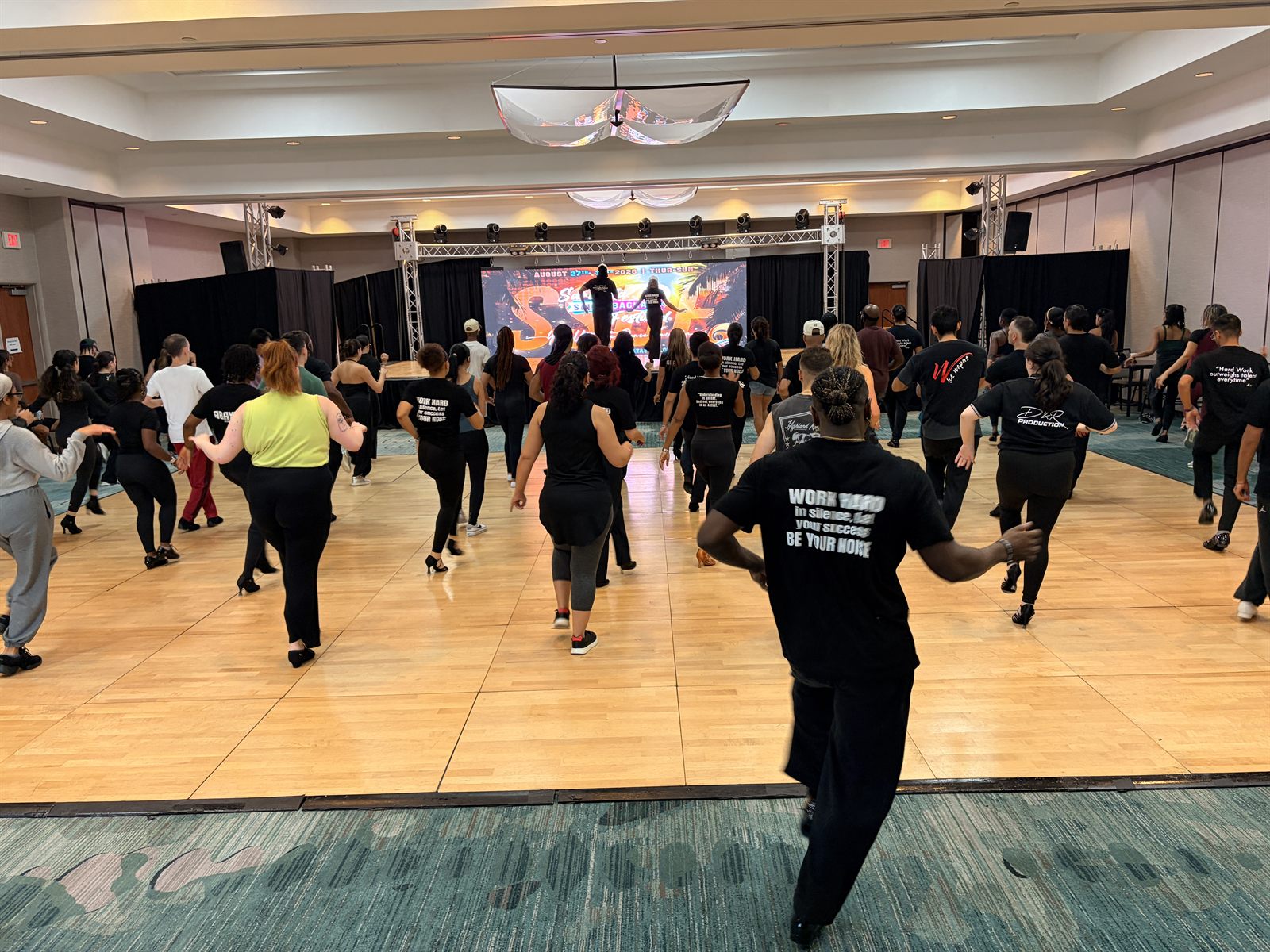 A full ballroom running the footwork together at the Sarasota festival